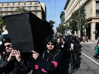 Με φέρετρο και κηδειόχαρτα μαυροφορεμένο...