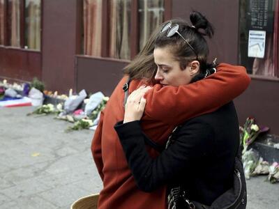 Two women embrace outside Le Carillon re...