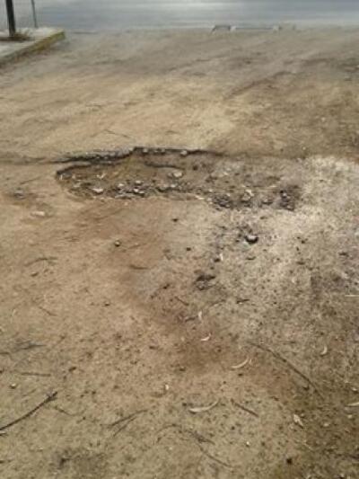 Λακκούβες στην είσοδο του πάρκινγκ. Περι...