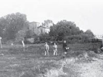 Μοναδικό πλάνο της περιοχής, το 1925. Πίσω από τους τρεις περαστικούς στο κτήμα, προφανώς οικογένεια, που στέκονται δίπλα στο κεντρωμένο δένδρο, διακρίνεται βοηθητικό -τότε- κτίσμα της «Μάμος ΑΕ» και που σήμερα στεγάζει το «Patras Youth Hostel» και στο βά