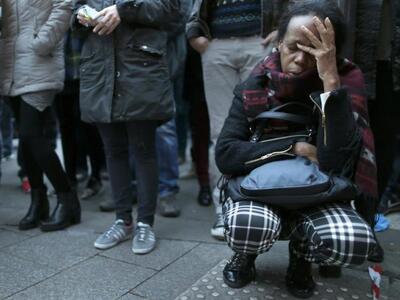 A woman pays her respect near the Batacl...